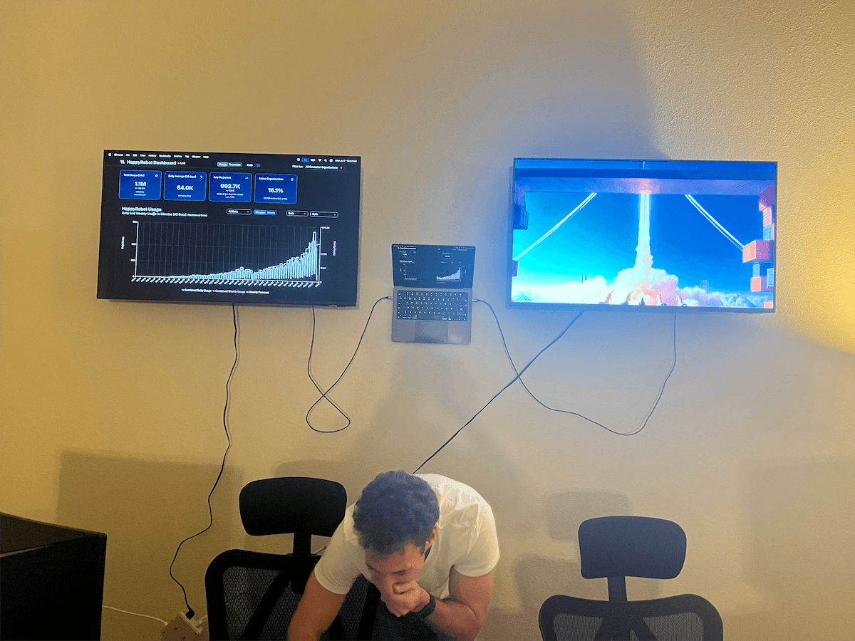 A moment in the office beneath the team dashboards